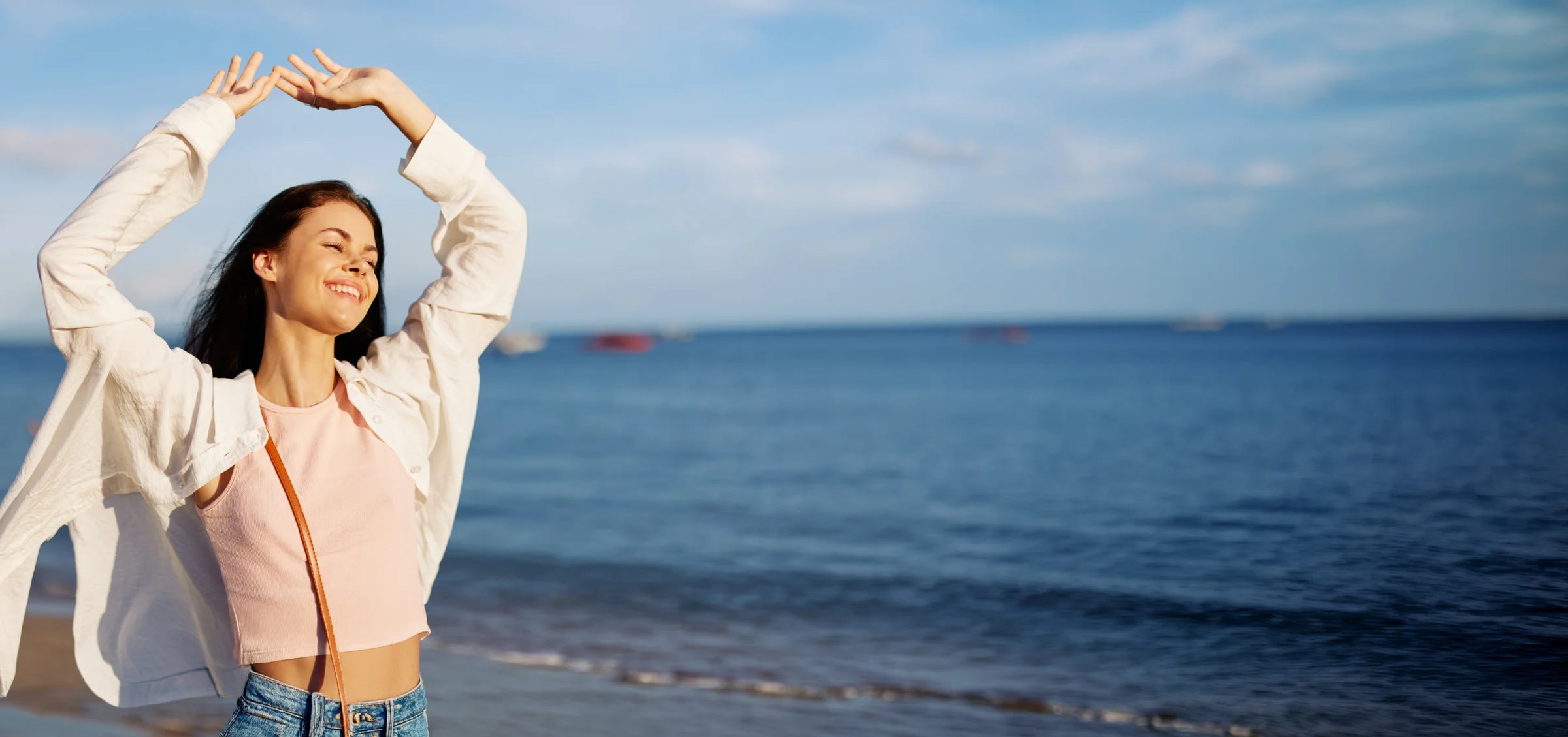 Woman stretching by the ocean